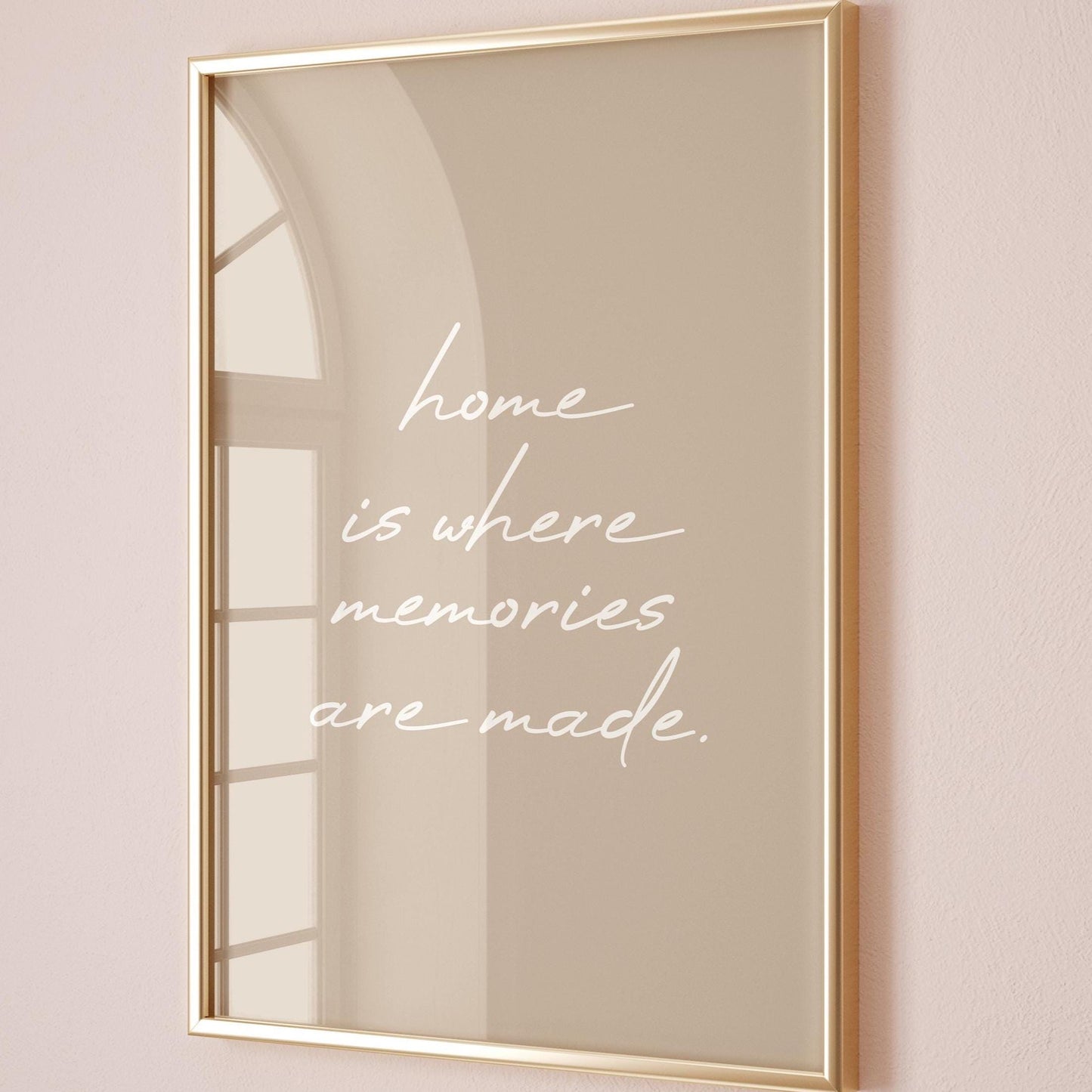 May include: A framed print with a gold-coloured frame. The print has a beige background with the white cursive text: "home is where memories are made."